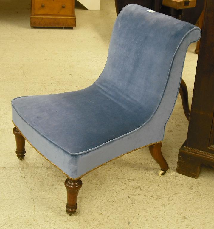 Appraisal: Victorian mahogany nursing chair upholstered in blue velvet