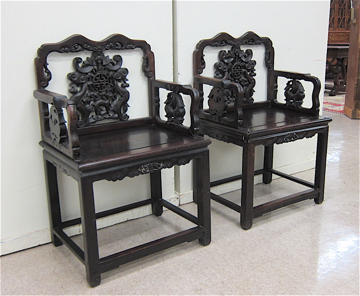 Appraisal: A PAIR OF CARVED HONGMU ARMCHAIRS Chinese early th century