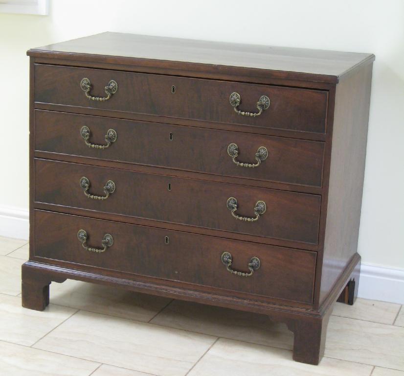 Appraisal: A George III mahogany Chest of long graduated drawers on