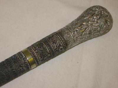 Appraisal: AN EASTERN CEREMONIAL STAFF the silver bulbous top embossed with