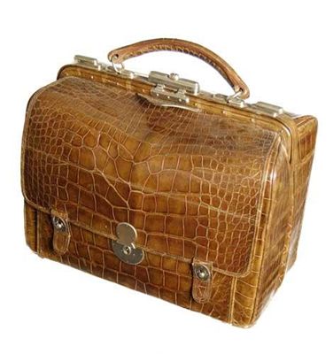 Appraisal: A crocodile Gladstone travelling bag with chrome mounts and a