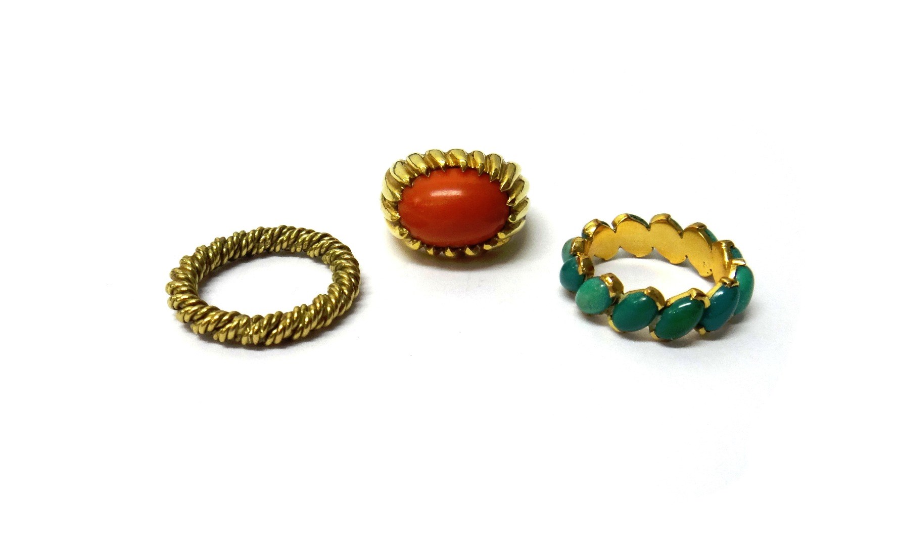 Appraisal: A gold ring mounted with an oval coral detailed a