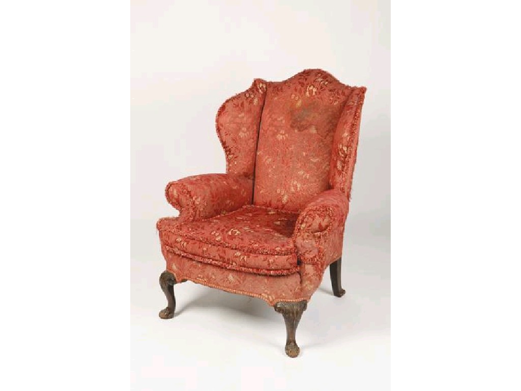 Appraisal: A GEORGE II STYLE WING ARMCHAIR with padded ears and