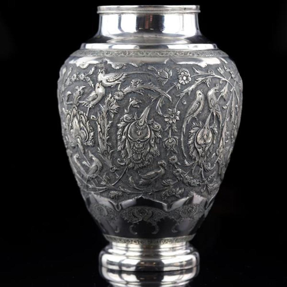 Appraisal: PERSIAN SILVER VASE WITH EXOTIC BIRDS AND FLORAL HEAVY REPOUSSE