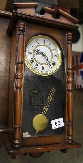 Appraisal: Wood cased reproduction keyhole wall clock