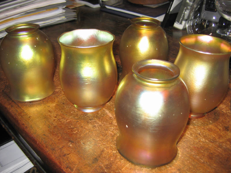 Appraisal: STEUBEN Five gold iridescent glass flori-form shades each signed and