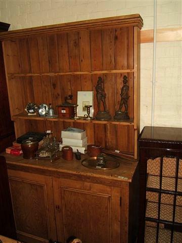 Appraisal: A Victorian pine dresser with plate rack above and cupboards