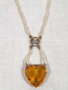 Appraisal: A seed pearl diamond and citrine pendant necklace the heart