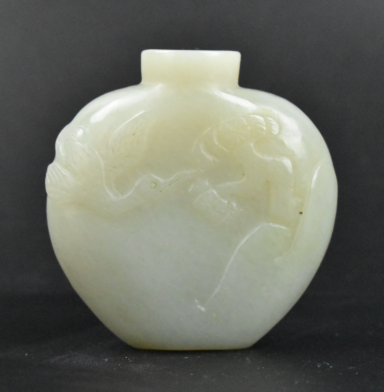 Appraisal: A rounded Chinese jade carved snuff bottle with crane Low