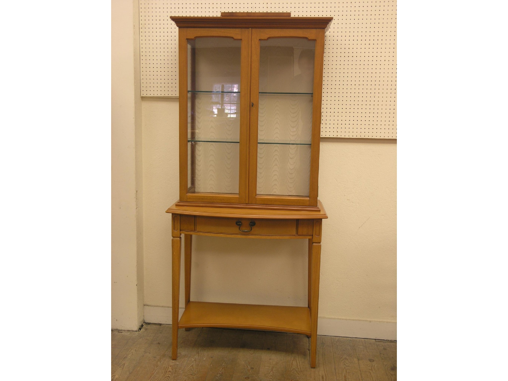 Appraisal: A reproduction light mahogany display cabinet floor-standing pair of glazed