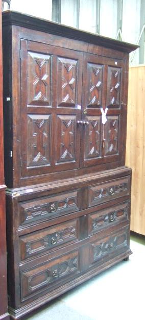 Appraisal: An oak press cupboard the upper section with shelves enclosed