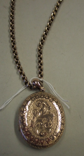 Appraisal: A Victorian oval pendant locket with scroll engraved decoration on