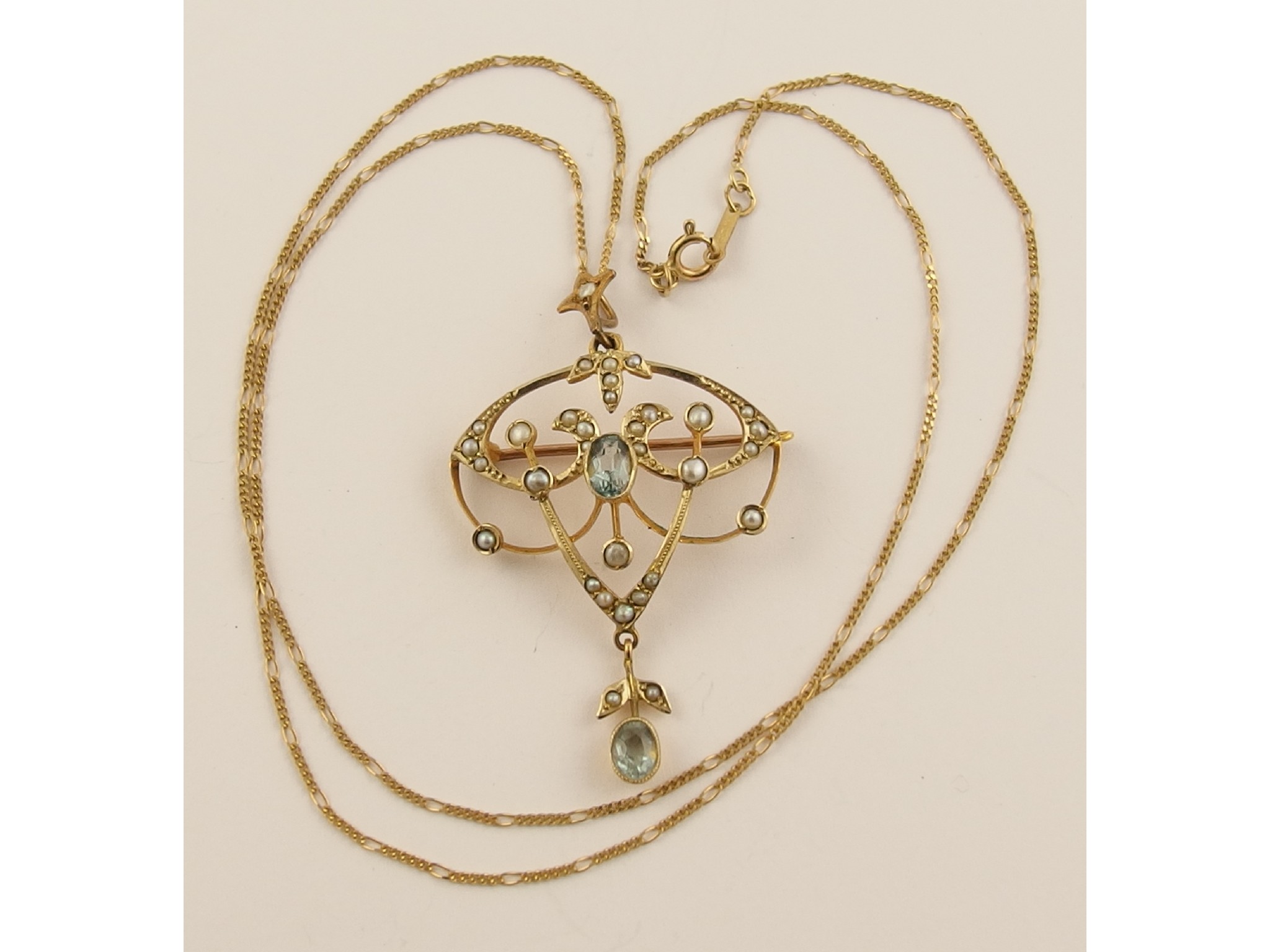 Appraisal: An Edwardian ct aquamarine and seed pearl pendant brooch and