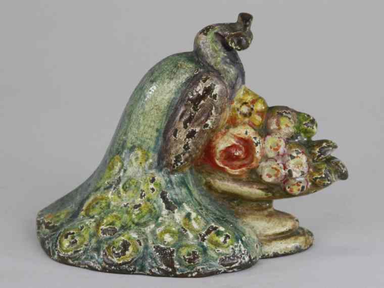 Appraisal: PEACOCK W FLOWERS DOORSTOP Depicts peacock w feathers down sitting