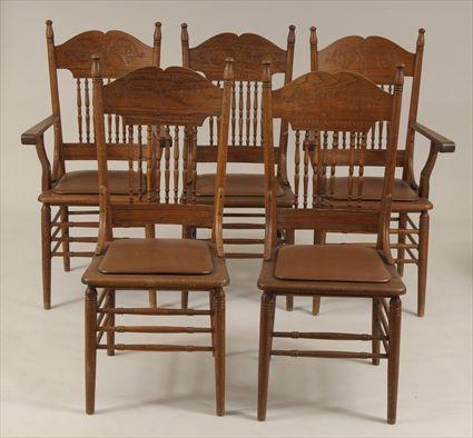 Appraisal: Six Golden Oak Pressed-Back Dining Chairs Comprising two armchairs and