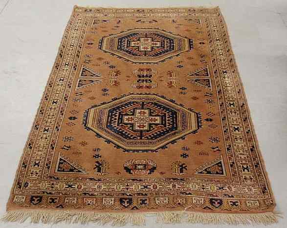 Appraisal: Turkish center hall carpet in a Kazak pattern overall brown