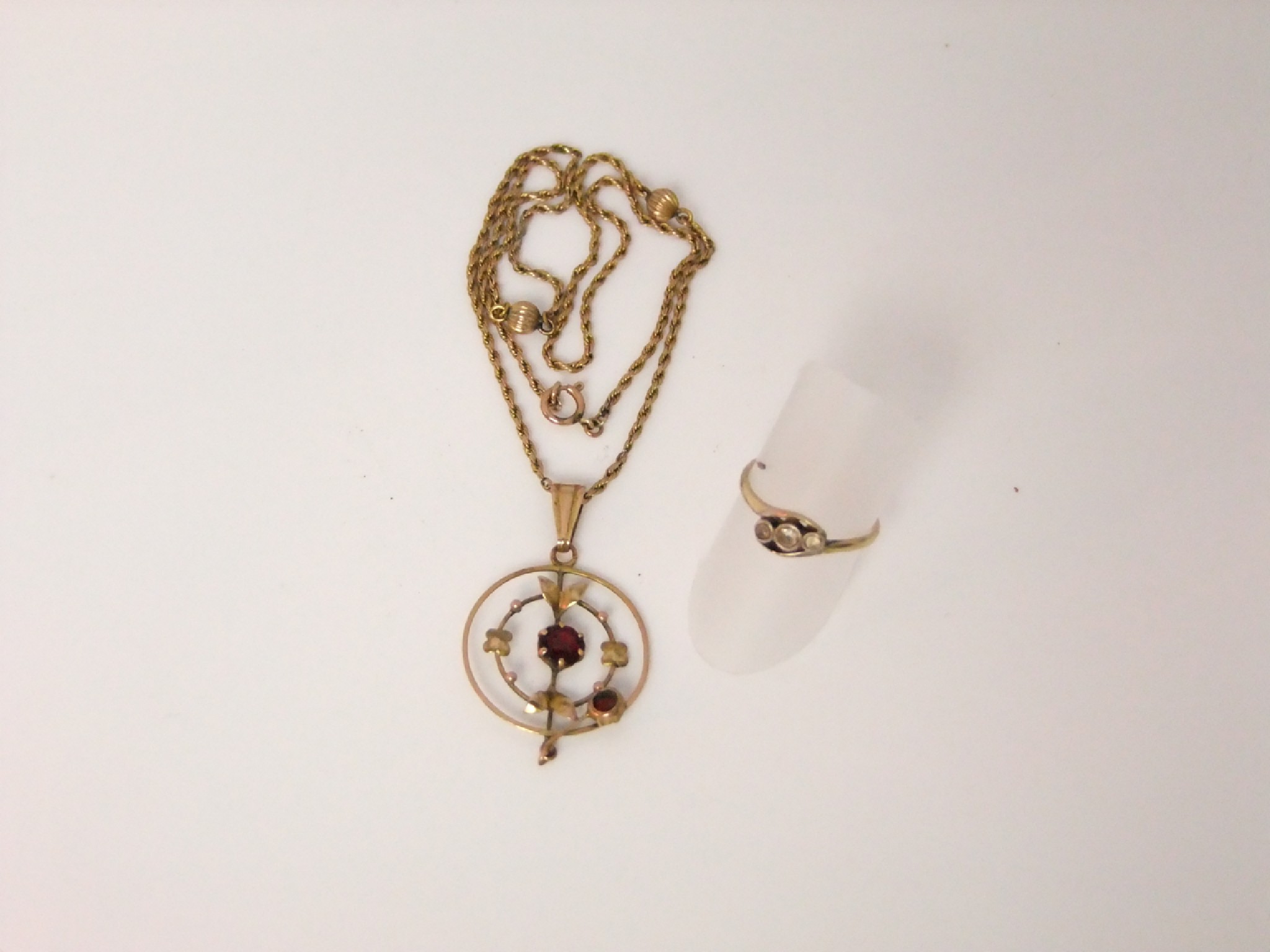 Appraisal: An Art Nouveau pendant set with a central garnet together