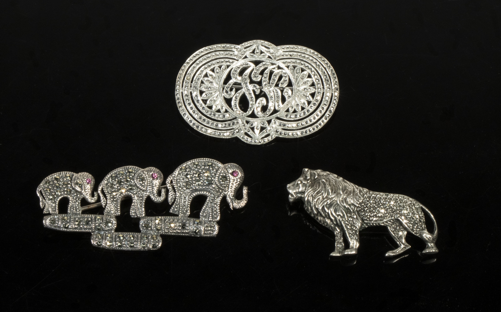 Appraisal: STERLING SILVER MARCASITE BROOCHES Lot of one with elephants one