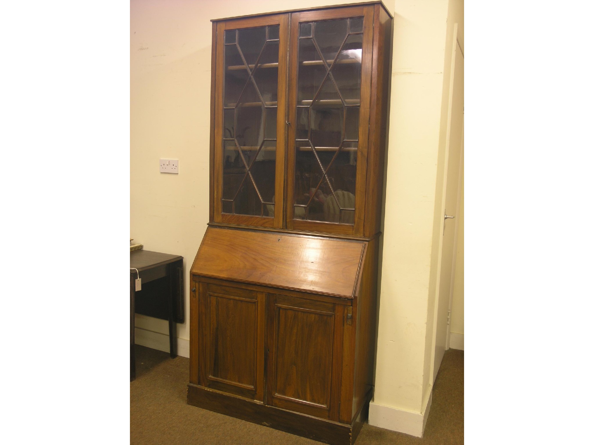 Appraisal: A Victorian walnut bureau bookcase pair of astragal-glazed doors enclosing