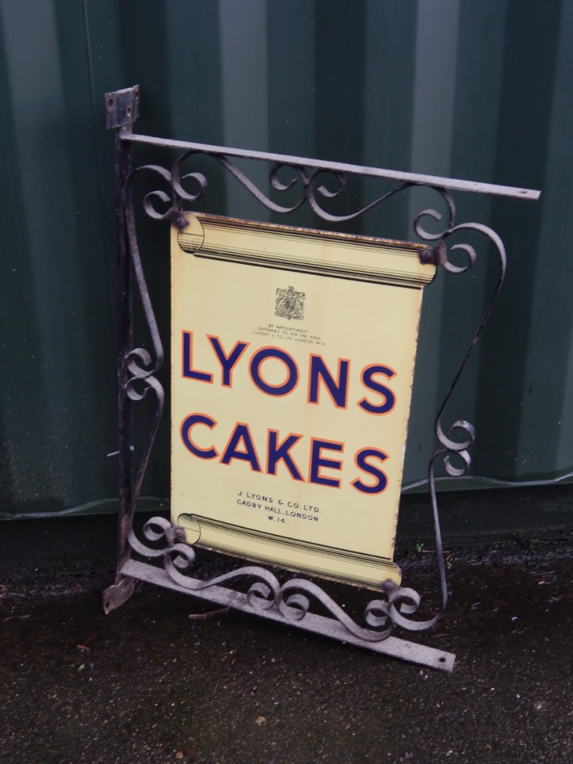 Appraisal: A Lyons Cakes enamel advertising sign in a scrolling block