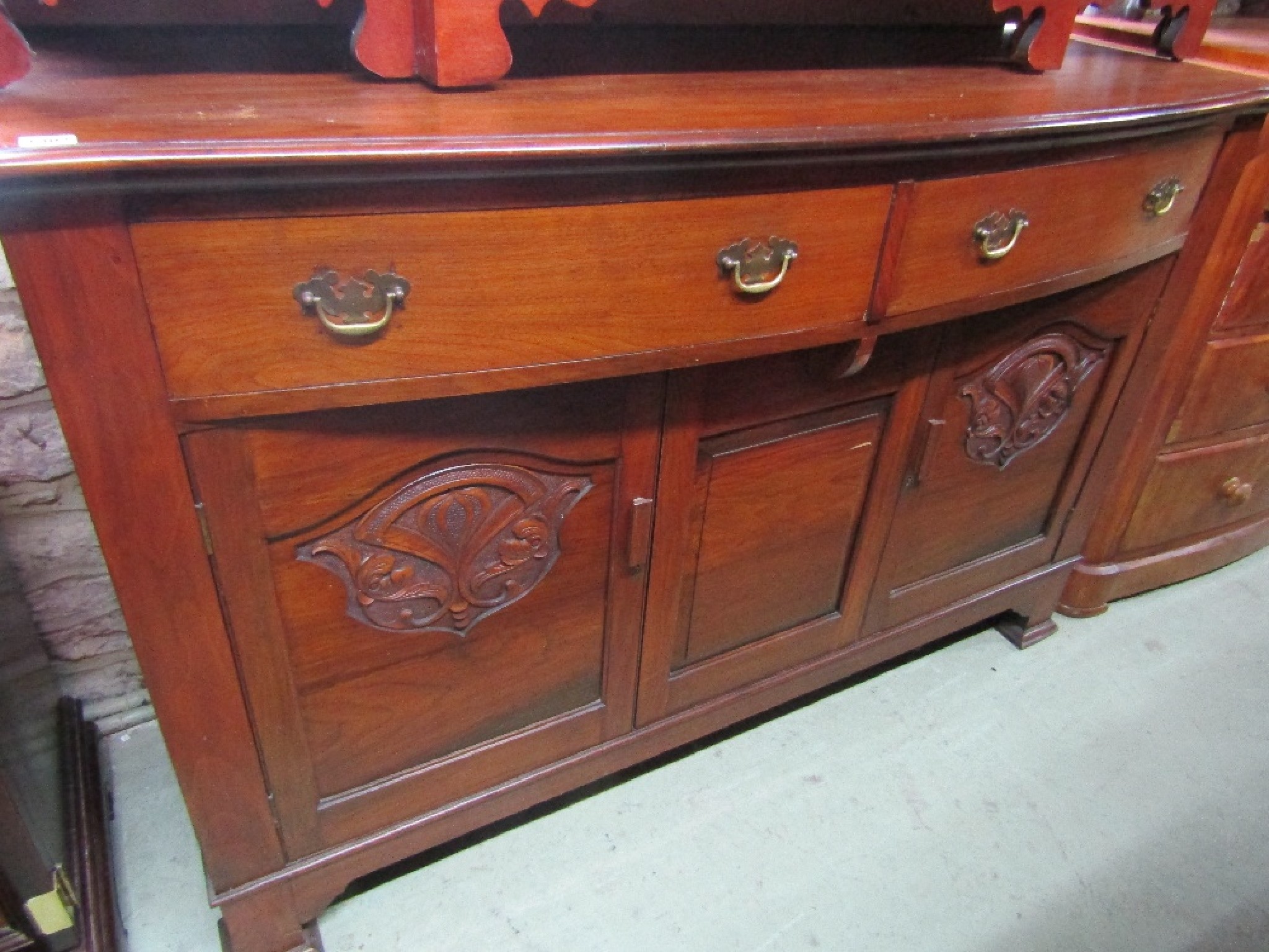 Appraisal: An Edwardian walnut sideboard in the Arts Crafts style fitted