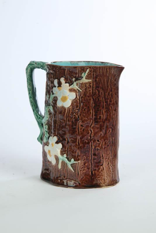 Appraisal: HOLDCROFT MAJOLICA PITCHER Brown treebark ground with Dogwood adornment and