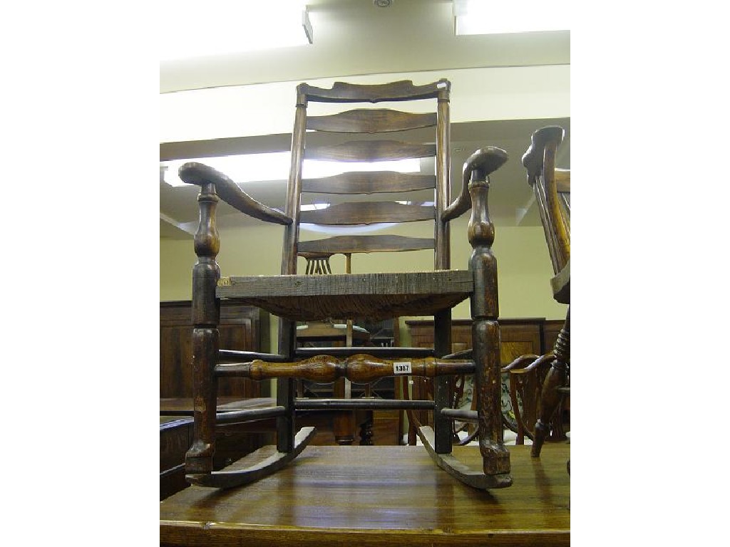 Appraisal: A Georgian ash wood ladder back open elbow chair with