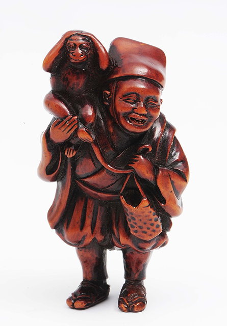 Appraisal: A Japanese wood netsuke of a Sarumawashi th Centurythe figure