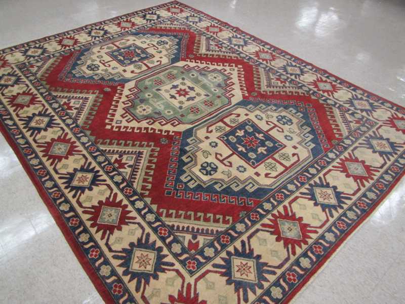 Appraisal: HAND KNOTTED ORIENTAL CARPET Caucasian Kazak design composed of three