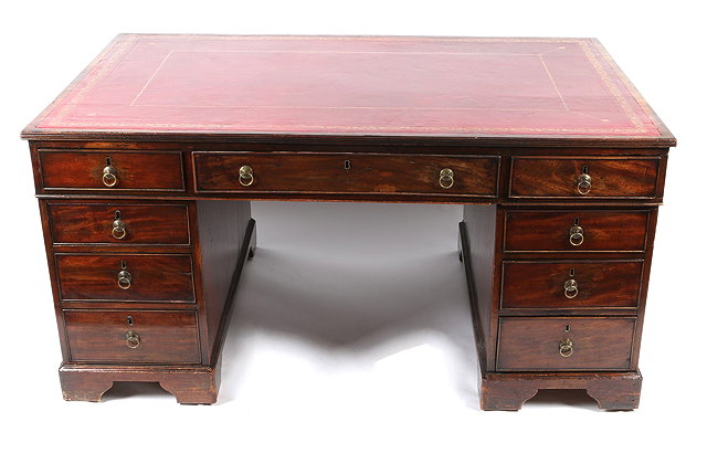 Appraisal: A LATE GEORGIAN MAHOGANY RECTANGULAR PARTNERS DESK with arrangement of