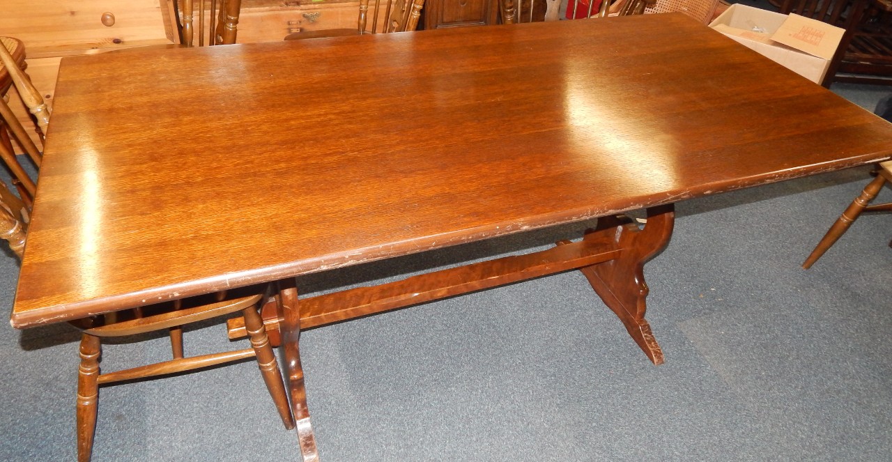 Appraisal: An oak refectory dining table raised on trestle end supports