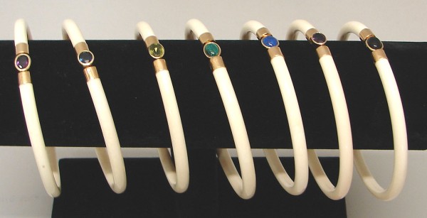 Appraisal: Seven wide ivory bracelets each with a gold mounted semi-precious