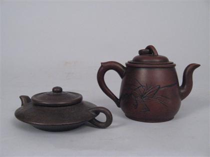 Appraisal: Two Chinese yixing teapots qing dynasty One of compressed globular