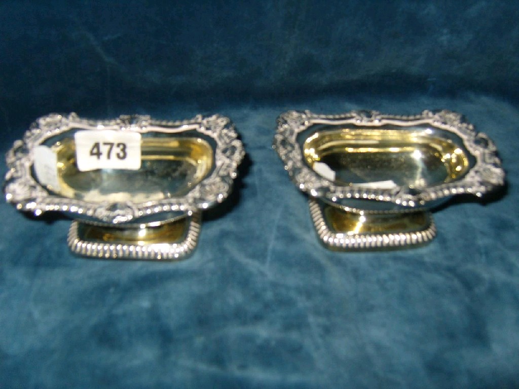 Appraisal: A pair of Georgian silver gilt salts with relief gadroon