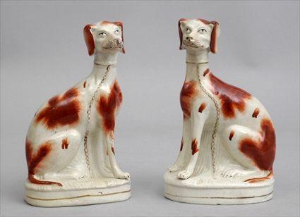 Appraisal: PAIR OF STAFFORDSHIRE FIGURES OF SPOTTED HOUNDS Each modeled seated