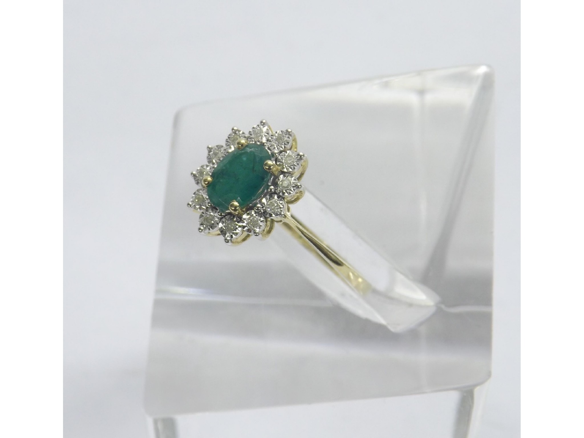 Appraisal: Attractive emerald and diamond oval cluster ring set in ct