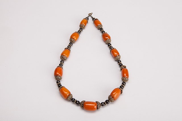 Appraisal: A MIDDLE EASTERN AMBER AND TRADE BEAD NECKLACE with filigr