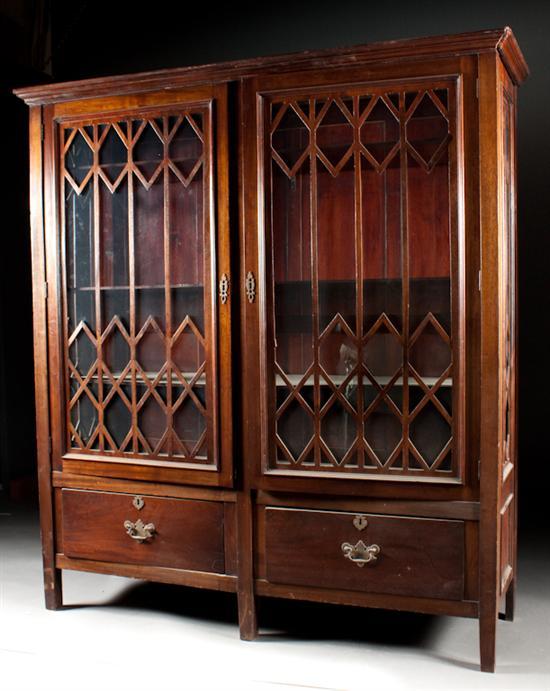 Appraisal: Late Victorian carved walnut glass panel two-door bookcase early th