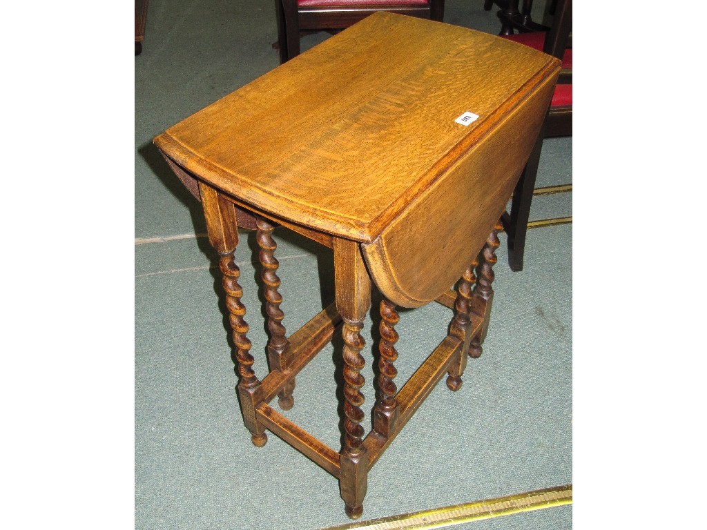 Appraisal: Oak drop leaf table with spiral twist supports