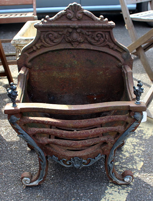 Appraisal: A ROCOCO STYLE CAST IRON FIRE BASKET the back with