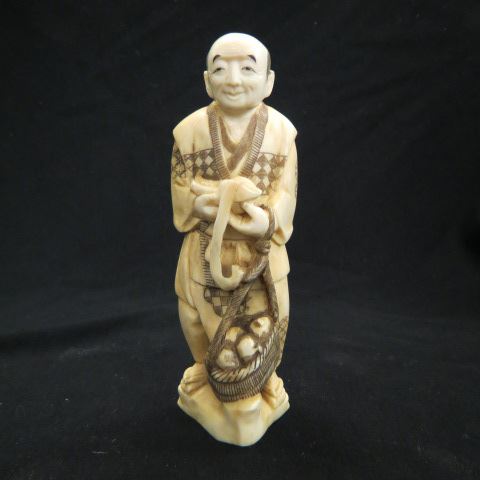 Appraisal: Chinese Carved Ivory Figurine of a Man peeling fruit signed