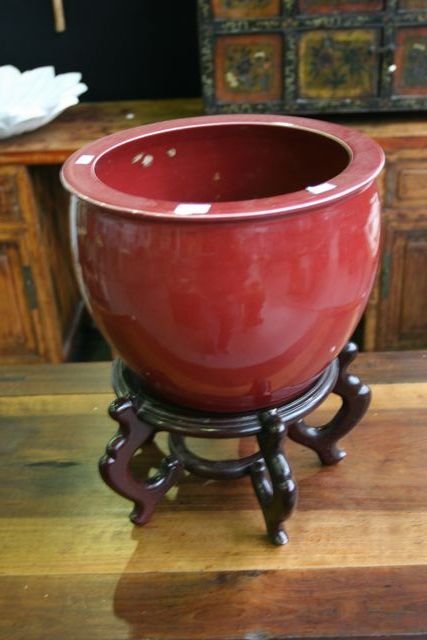 Appraisal: An ox blood glaze Chinese pot on a wooden stand