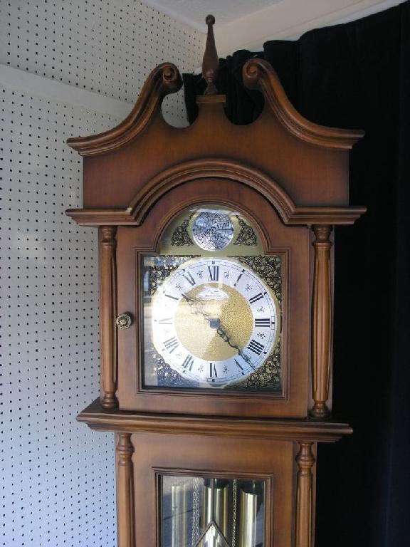 Appraisal: A reproduction longcase clock traditional arched dial glazed trunk door