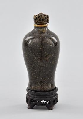 Appraisal: A Glazed Ceramic Snuff Bottle and Carved Wood Stand The