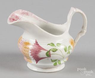 Appraisal: Yellow and red rainbow spatter creamer with thistle decoration ''