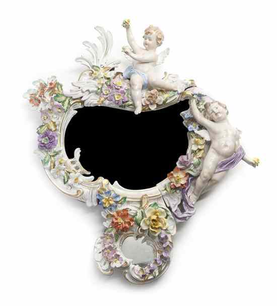 Appraisal: A Continental Porcelain Mirror of cartouche form with applied foliate