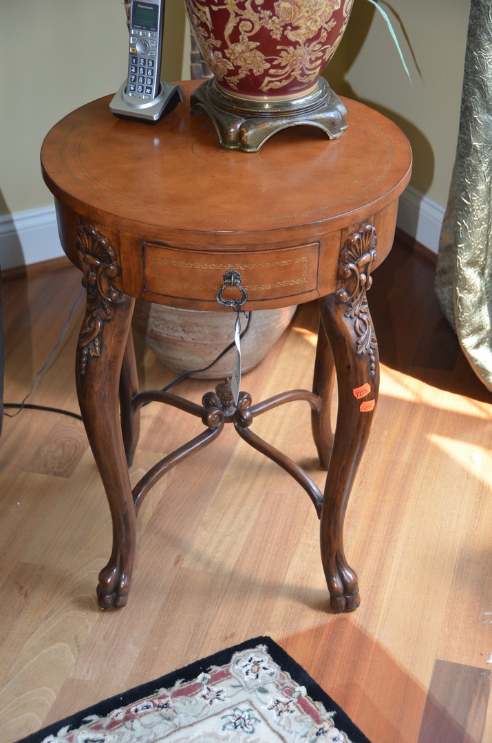 Appraisal: Round carved fruitwood Italian style lamp table with faux leather