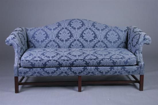 Appraisal: CHIPPENDALE STYLE CAMEL-BACK SOFA th century With serpentine crest rail