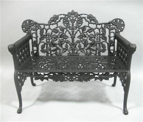 Appraisal: BLACK PAINTED WROUGHT IRON GARDEN BENCH th century the shaped