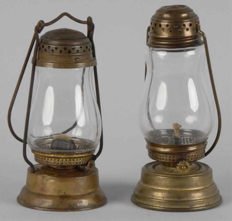 Appraisal: Pair of Skater's Brass Oil Lamps Description One marked Dietz